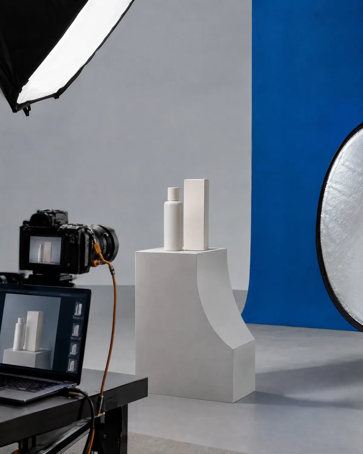 Product photography setup with camera, softbox and pedestal in the studio